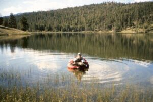 A small lake in BC’s backcountry with clear water and defined shoals